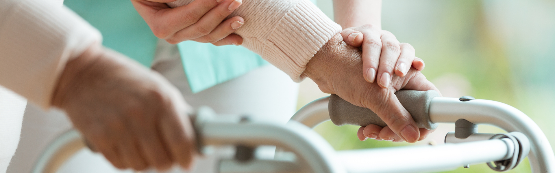 Patients hands on metal walker