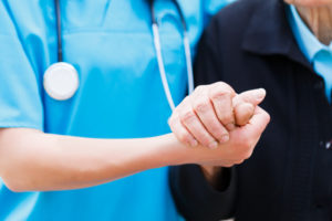 Nurse holding patient's hand